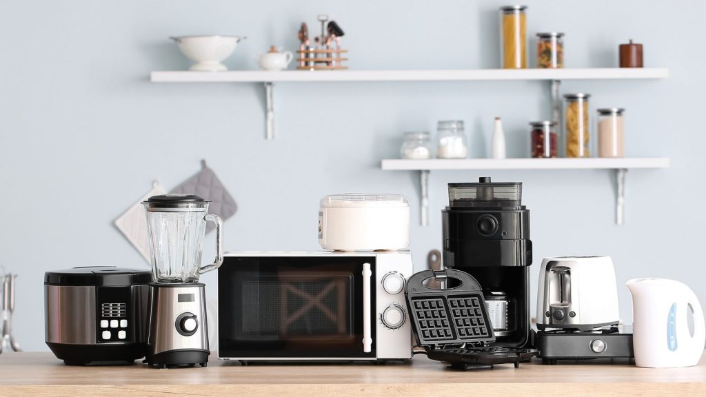 A bunch of small kitchen appliances arranged on a counter 